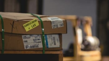 Customs Brokerage Stacked boxes with cleared customs labels