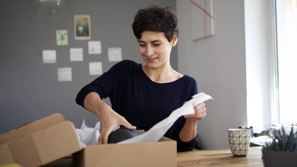Woman packing a box for UPS Woman packing a box for UPS