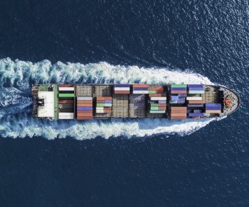News & Market Updates aerial top down view of container ship