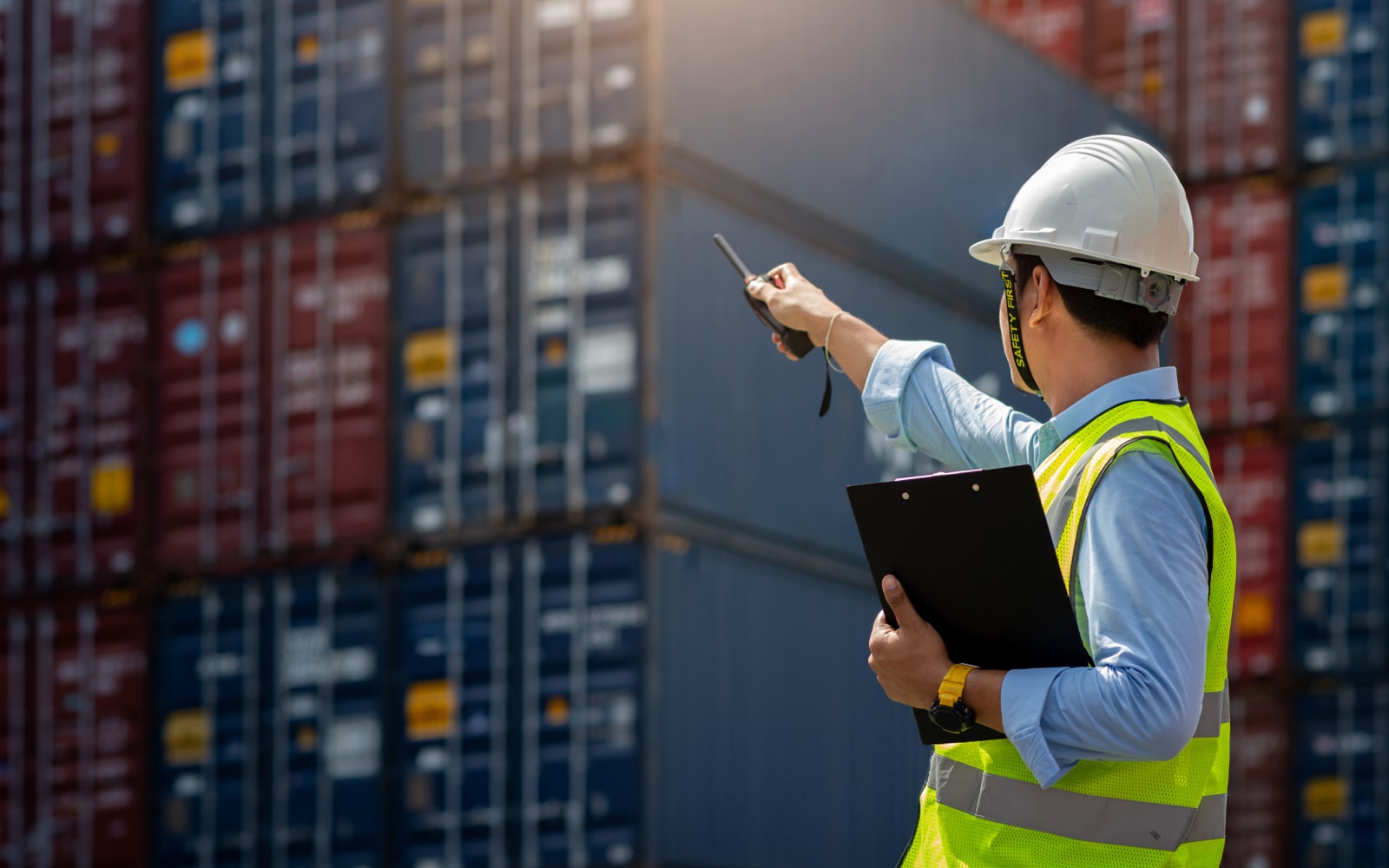 Shipping controller on loading dock with shipping containers