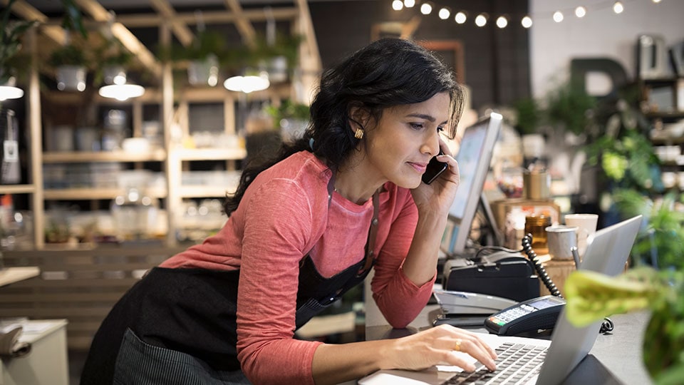 Woman on the phone using a laptop Woman on the phone using a laptop
