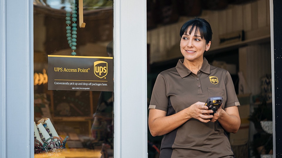 A UPS driver using a digital tablet at a UPS Access Point. A UPS driver using a digital tablet at a UPS Access Point.