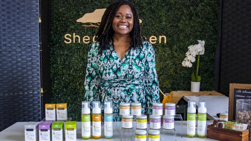 Shea Yeleen standing behind a table with her beauty products Shea Yeleen standing behind a table with her beauty products