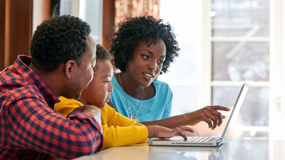 Family looking at laptop Family looking at laptop